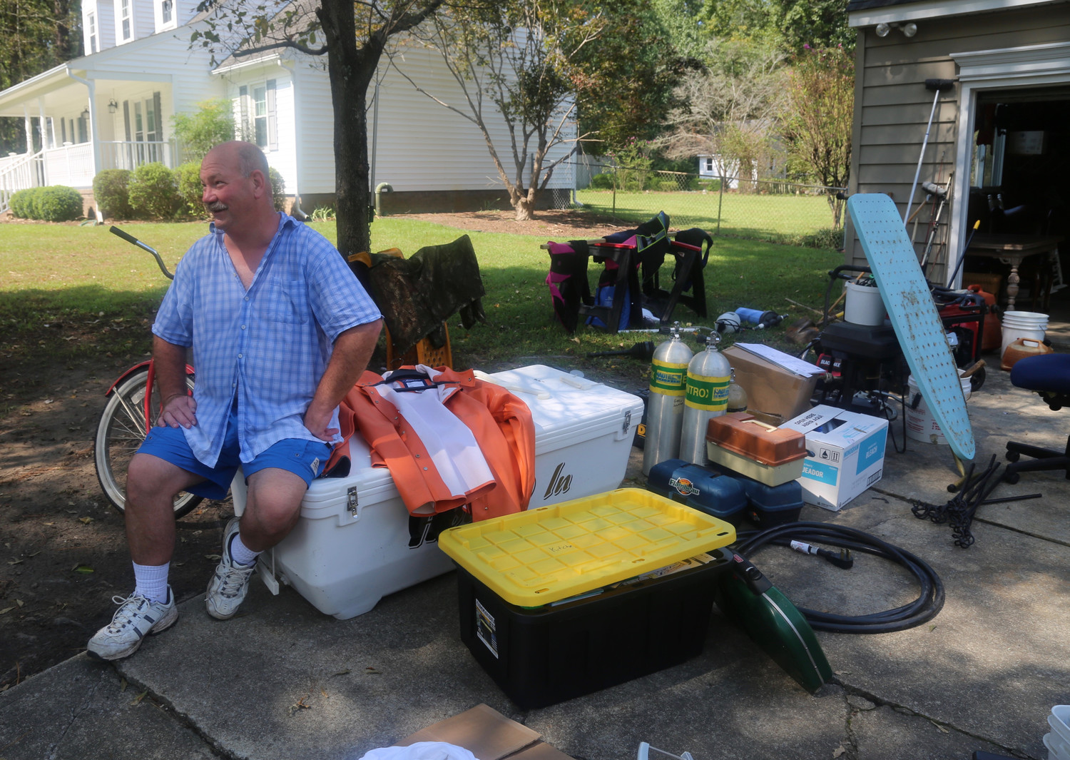 Gary Johnson sits outside his home in Trent Woods, North Carolina, Sept. 22. The house was flooded during Hurricane Florence, and Johnson, his wife, Megan, and their two daughters are unable to live in it.
